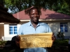 A South Sudanese man holds a sign stating 