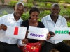Three young South Sudanese professional holds a sign stating 