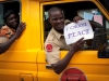 A private security guard (right) and member of South Sudan\'s security force (left) holds a sign stating 