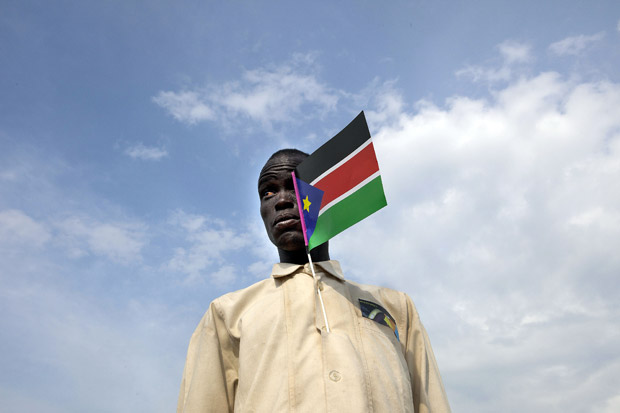 A Sudanese man holds the national flag attending a cultural festival to celebrate the South Sudan's anniversary July 7, 2012 in Juba, South Sudan. (Paula Bronstein/Getty Images)